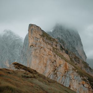 Preview wallpaper rock, cliff, fog, slope, mountains