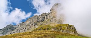 Preview wallpaper rock, cliff, fog, clouds, grass