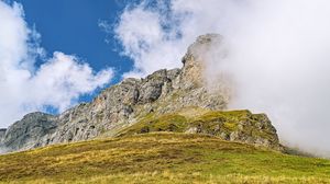 Preview wallpaper rock, cliff, fog, clouds, grass