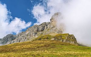 Preview wallpaper rock, cliff, fog, clouds, grass