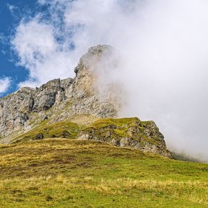 Preview wallpaper rock, cliff, fog, clouds, grass