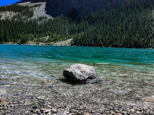 Preview wallpaper rock, cliff, lake, pebbles