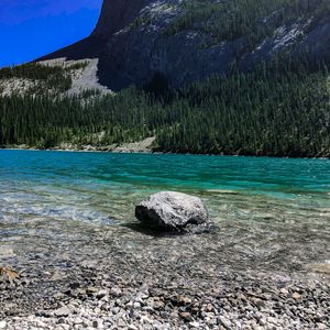 Preview wallpaper rock, cliff, lake, pebbles