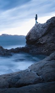 Preview wallpaper rock, cliff, man, sea, loneliness, water