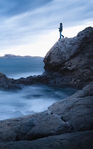 Preview wallpaper rock, cliff, man, sea, loneliness, water