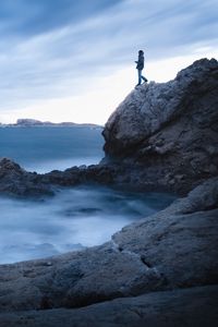 Preview wallpaper rock, cliff, man, sea, loneliness, water