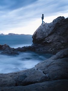 Preview wallpaper rock, cliff, man, sea, loneliness, water