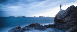 Preview wallpaper rock, cliff, man, sea, loneliness, water