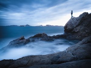 Preview wallpaper rock, cliff, man, sea, loneliness, water