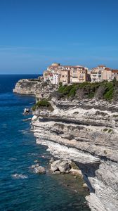 Preview wallpaper rock, cliff, sea, buildings, houses