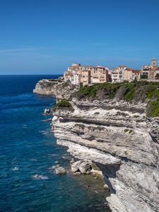 Preview wallpaper rock, cliff, sea, buildings, houses