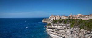 Preview wallpaper rock, cliff, sea, buildings, houses