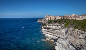 Preview wallpaper rock, cliff, sea, buildings, houses