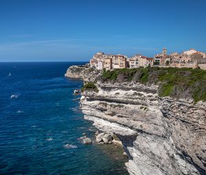 Preview wallpaper rock, cliff, sea, buildings, houses