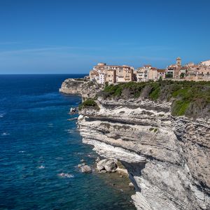 Preview wallpaper rock, cliff, sea, buildings, houses