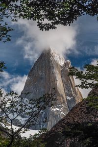 Preview wallpaper rock, cliff, steep, high, cloud, branches, trees