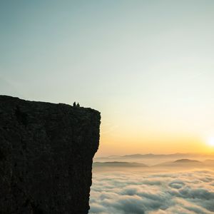 Preview wallpaper rock, couple, clouds, sunset, nature