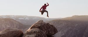 Preview wallpaper rock, jump, freedom, mountains, stones, man