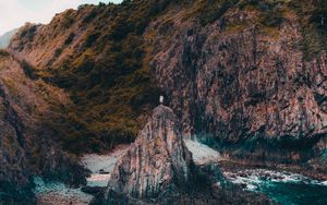 Preview wallpaper rock, man, alone, sea, coast, nature