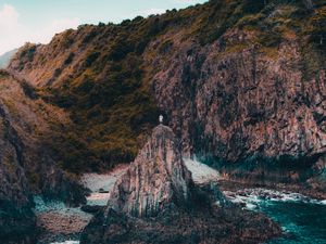 Preview wallpaper rock, man, alone, sea, coast, nature