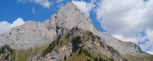 Preview wallpaper rock, mountain, slope, trees, house, trail, grass