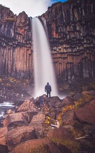 Preview wallpaper rock, mountain, waterfall, man, silhouette, stones