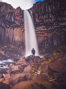 Preview wallpaper rock, mountain, waterfall, man, silhouette, stones