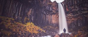 Preview wallpaper rock, mountain, waterfall, man, silhouette, stones