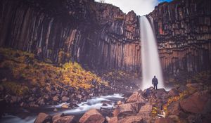 Preview wallpaper rock, mountain, waterfall, man, silhouette, stones