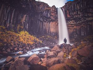 Preview wallpaper rock, mountain, waterfall, man, silhouette, stones