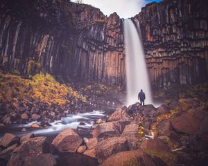 Preview wallpaper rock, mountain, waterfall, man, silhouette, stones