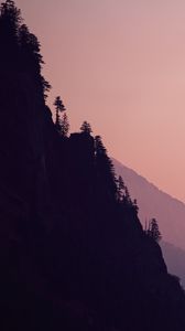 Preview wallpaper rock, mountains, trees, evening, cliff