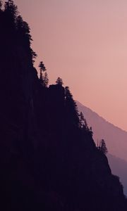 Preview wallpaper rock, mountains, trees, evening, cliff