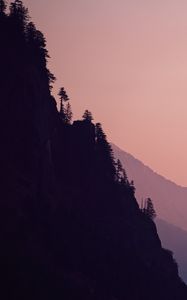 Preview wallpaper rock, mountains, trees, evening, cliff