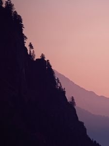 Preview wallpaper rock, mountains, trees, evening, cliff