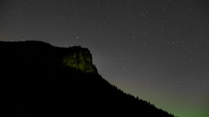 Preview wallpaper rock, night, starry sky, stars, slope