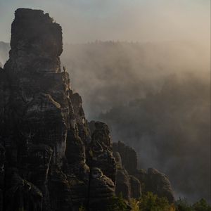 Preview wallpaper rock, peak, fog, trees, landscape