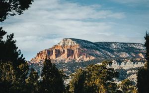 Preview wallpaper rock, peak, mountain, trees, branches