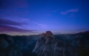 Preview wallpaper rock, peak, mountains, sunset, clouds