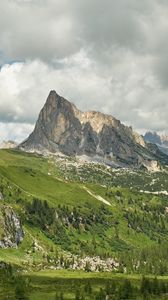 Preview wallpaper rock, peak, slope, grass, clouds