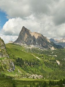 Preview wallpaper rock, peak, slope, grass, clouds