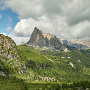 Preview wallpaper rock, peak, slope, grass, clouds