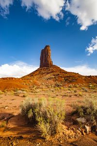 Preview wallpaper rock, prairie, bushes, sand, sky