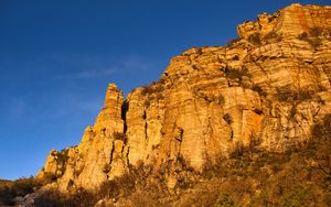 Preview wallpaper rock, relief, bushes, sky