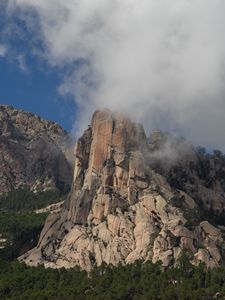 Preview wallpaper rock, relief, trees, clouds, view