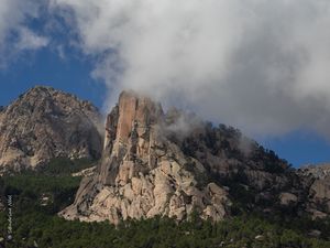 Preview wallpaper rock, relief, trees, clouds, view