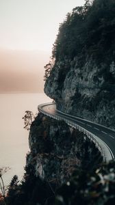 Preview wallpaper rock, road, cliff, sea, sunset
