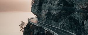 Preview wallpaper rock, road, cliff, sea, sunset