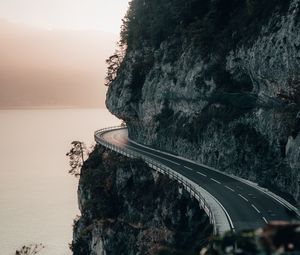 Preview wallpaper rock, road, cliff, sea, sunset