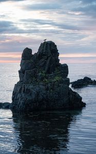 Preview wallpaper rock, sea, silhouette, nature, evening